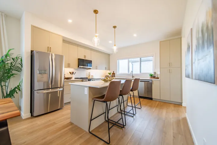 Kitchen with a quartz island and stainless appliances